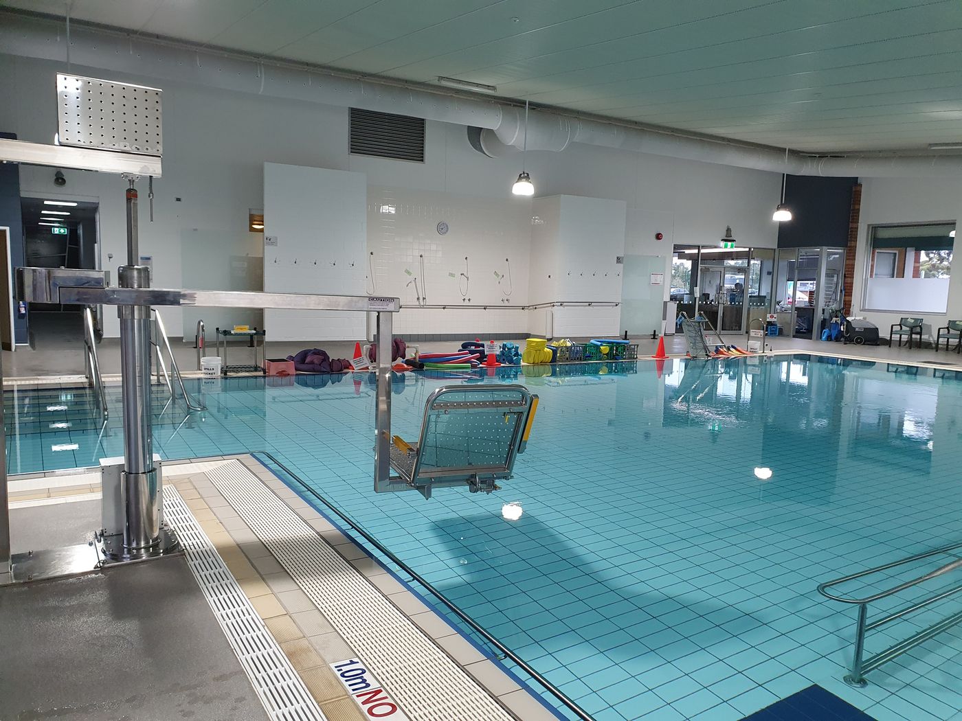 The pool hoist positioned over the warm water